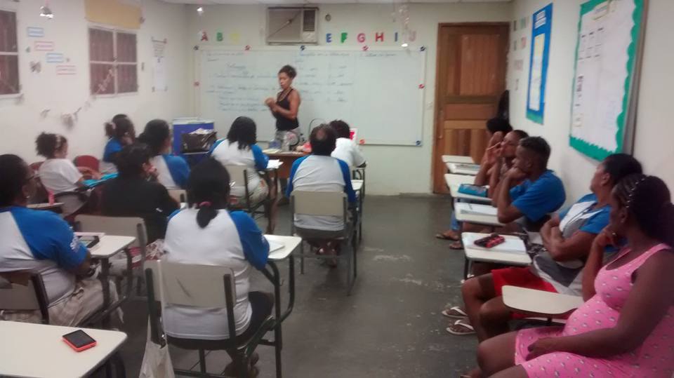 em uma sala de aula a Cris faz uma palestra para concientização do trabalho em conjunto
